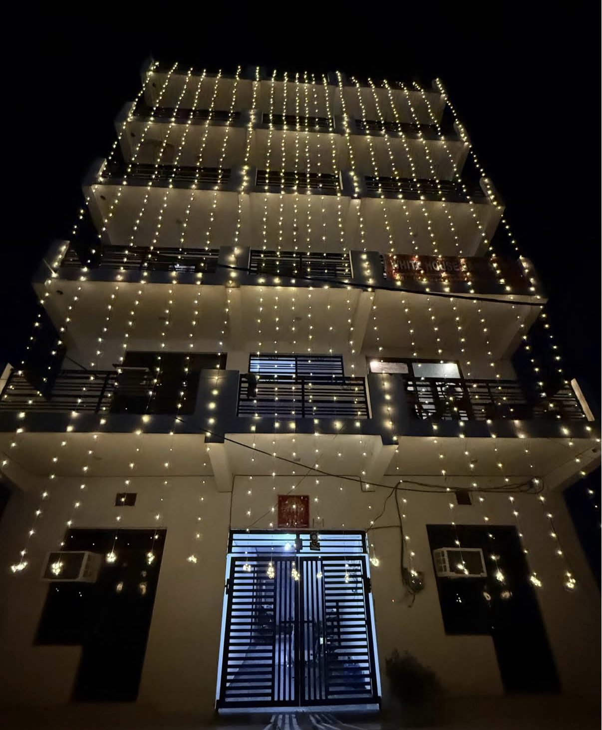 The PG building decorated with festive string lights