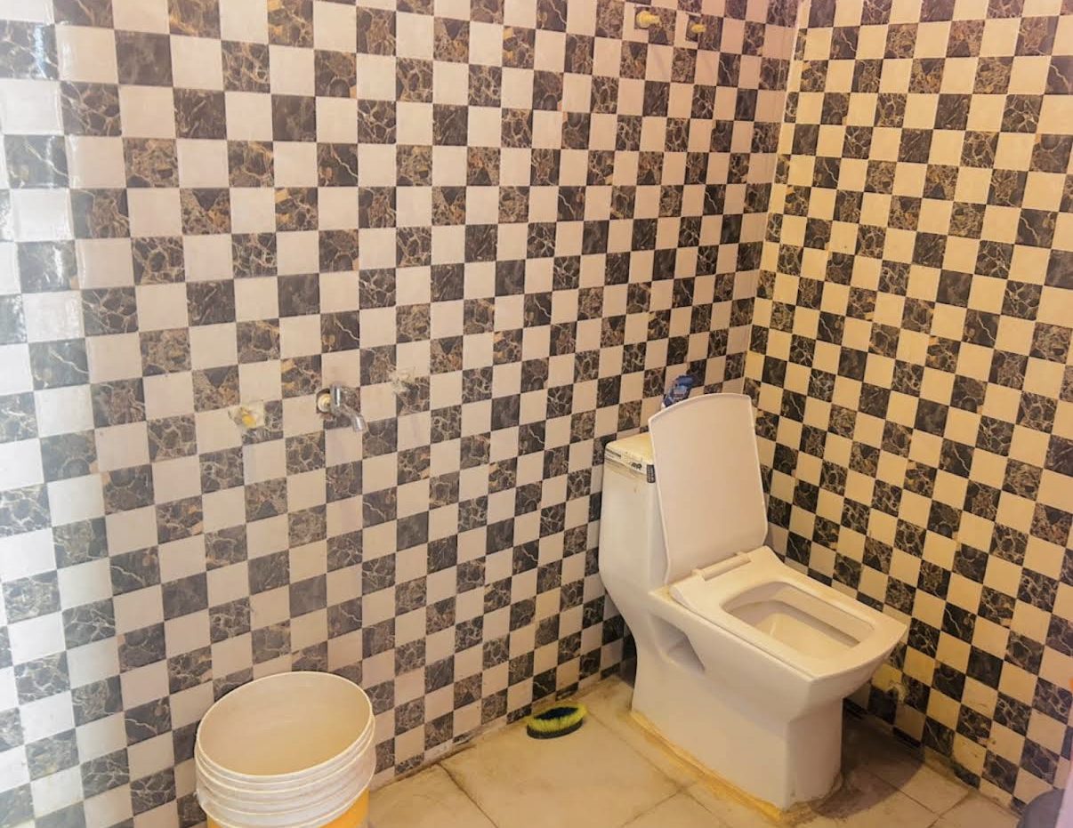 Tiled attached washroom with western toilet